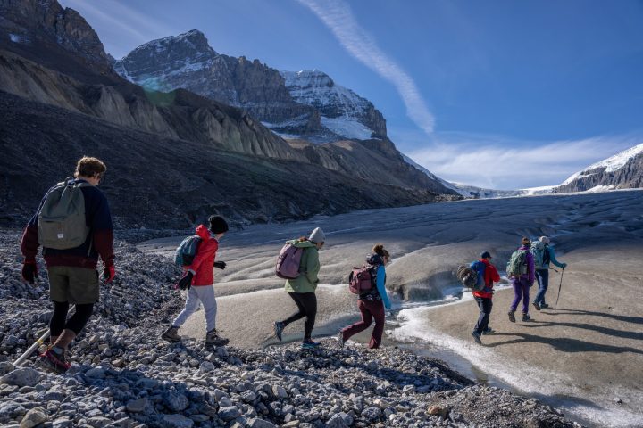 a group of people standing on top of a mountain
