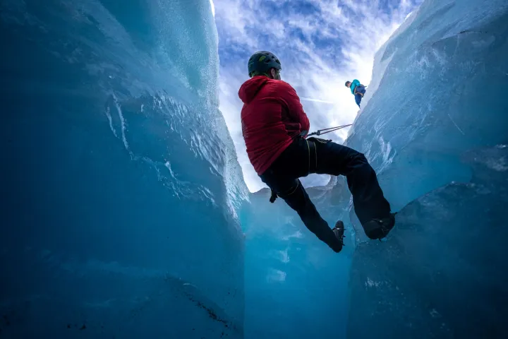 a man riding a snowboard down a snow covered mountain