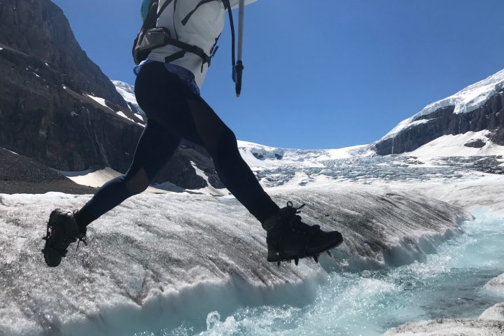a man riding a snowboard down a snow covered mountain