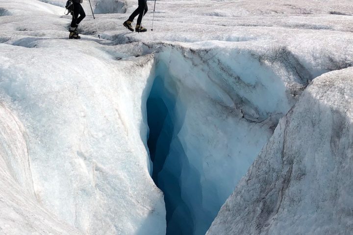 a man riding a snowboard down a snow covered mountain
