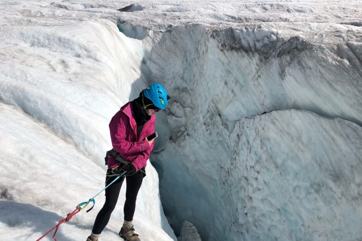a person riding skis down a snow covered mountain