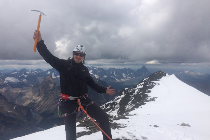 Alpine climber on top of mountain