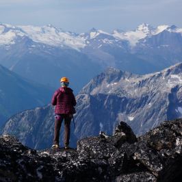 Women with back to the camera looking out over mountain vista