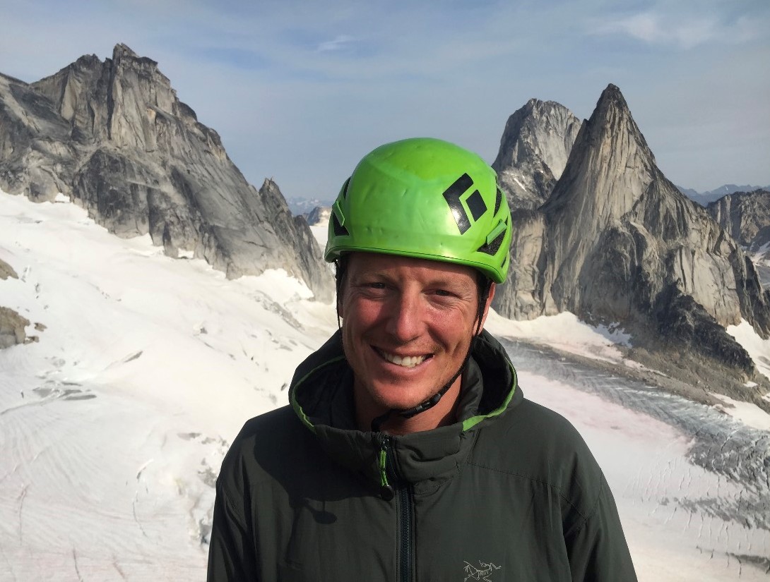 jesse1 a man wearing a green hat and a snow covered mountain