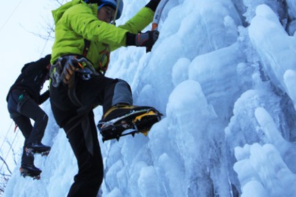 a man riding a snowboard down a snow covered slope