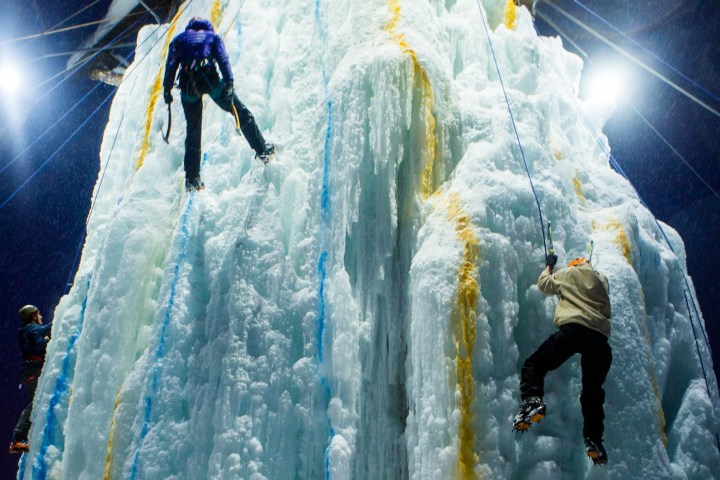 a group of people riding skis on top of a snow covered slope